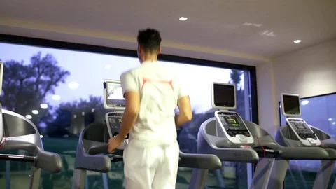 Man runs on treadmill Stock Footage 128798026