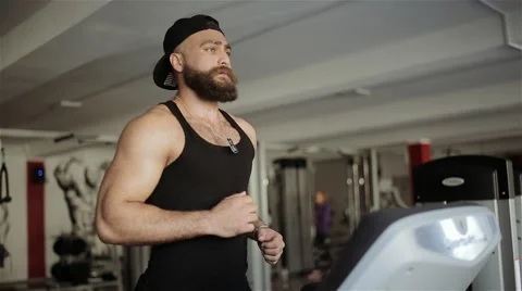 A man runs on a treadmill in the gym Stock Footage 56636152