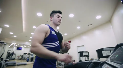 A man runs on a treadmill in the gym Stock Footage 59162857