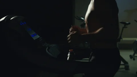 Man runs on a treadmill at the gym Stock Footage 100677603