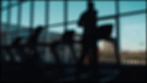 Man runs on a treadmill on a window background 스톡 동영상 88830043