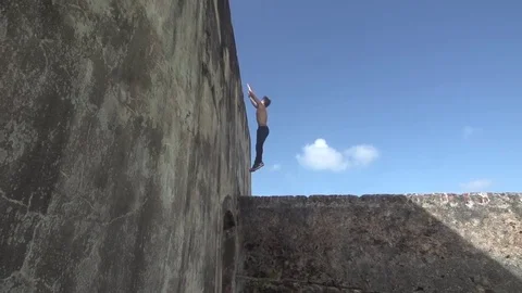 Man Runs Up Wall And Climbs To the Top Parkour Chase Escape Stock Footage 79277425