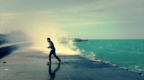 Man Runs from Waves, Slow-Motion Stock Footage 38354186