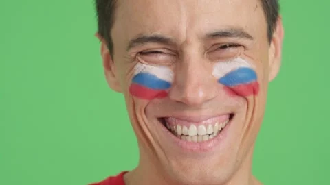 Man with a russian flag painted on the face smiling Stock Footage 273210650
