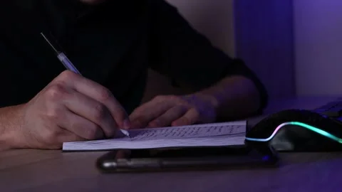 A man 's hand writes in a diary writer the person writes Stock Footage 169326221