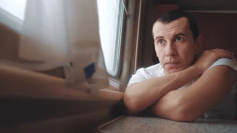 Man sad bored riding a train railway looks lifestyle out the window. traveler Stock Footage 108163370