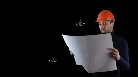A man in safe helmet read blueprints in the flying out black calculations Stock Footage 87168311