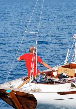 Man on a sailboat Stock Photos