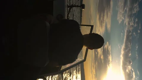 A man is sailing on a boat at sunset. A modern fisherman floats on a small boat 库存影片 203919086