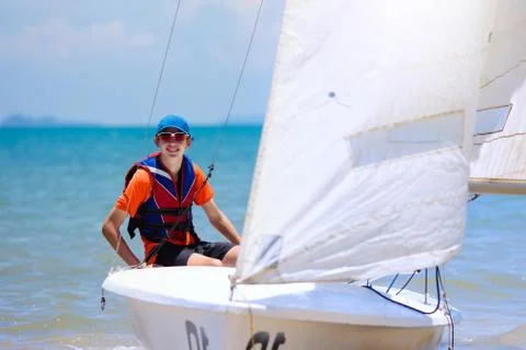 Man sailing. Boy learning to sail on sea yacht. Stock Photos