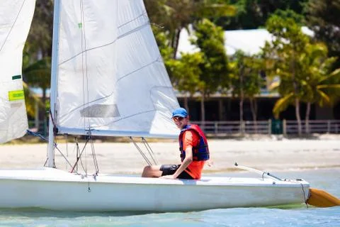 Man sailing. Boy learning to sail on sea yacht. Stock Photos