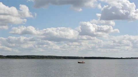Man sailing a motorboat on the lake on a cloudy summer day – time lapse Stock Footage 62192607