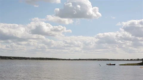 Man sailing off a river bank on a small boat rowing with oars Stock Footage 62193055