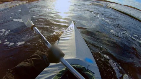 Man sails on kayak with paddle in river with sun reflection Stock Footage 125007682
