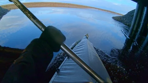 Man sails on kayak using paddle under bridge against nature Stock Footage 123411278