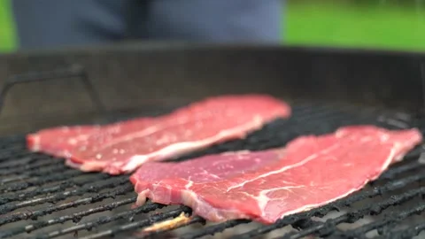 Man salts bbq meat Stock Footage 158183769