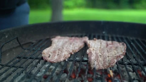 Man salts cooked steaks Stock Footage 158183770