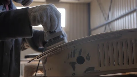 Man sanding a car detail Stock Footage 119451069
