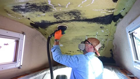 Man sanding the ceiling of a camper van Stock-Footage 347636877