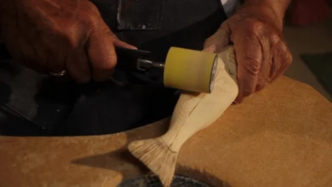 Man Sanding Down Wooden Fish Wood Carving 動画素材 103494533