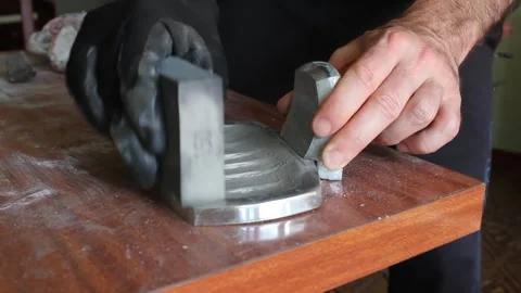 Man sanding metal objects in a bathroom Stock Footage 249361085