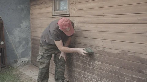 Man Sanding Wooded Wall Using Hand Sander Stock Footage 116556504