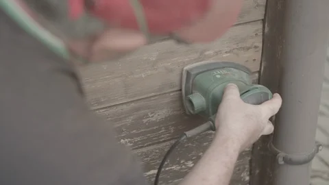 Man Sanding Wooded Wall Using Hand Sander Stock Footage 116560771