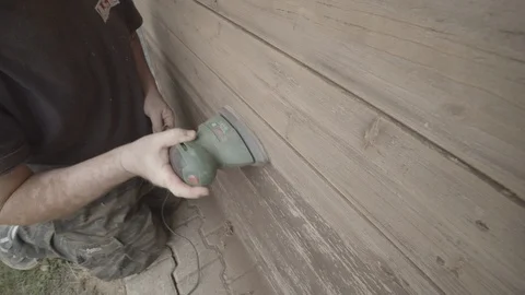 Man Sanding Wooded Wall Using Hand Sander Stock Footage 116561212
