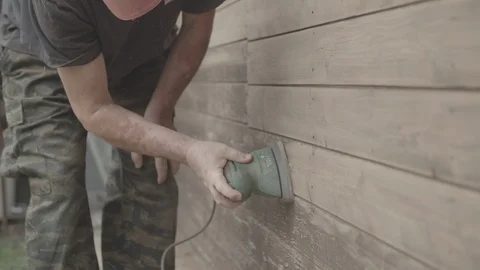 Man Sanding Wooded Wall Using Hand Sander Stock Footage 116562420