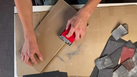 Man sanding wooden surface using red sanding block holder. Top view of DIY .. Stock Footage 318673193
