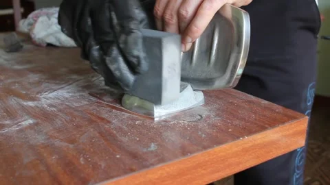 Man sands metal objects from a bathroom Stock Footage 249361082