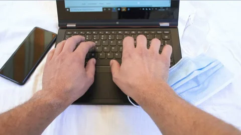 Man sanitize hands while working on web business in coronavirus pandemic disease Stock Footage 136036426