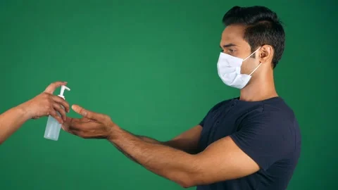 A man sanitizing his hands during COIVD times - Health safety Stock Footage 161864001