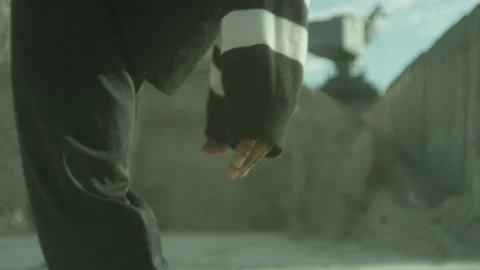 A man in a sanpit bends backwards with focus on hands Stock Footage 231111389