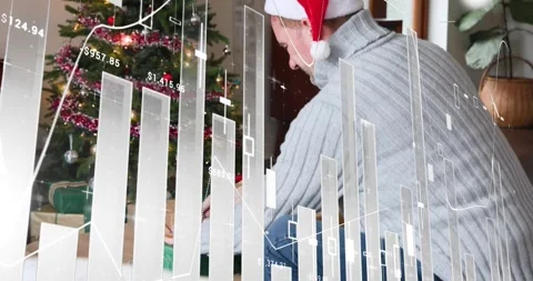 Man in Santa hat kneeling, picking gift and placing it under Xmas tree, finance Stock Footage 321715610