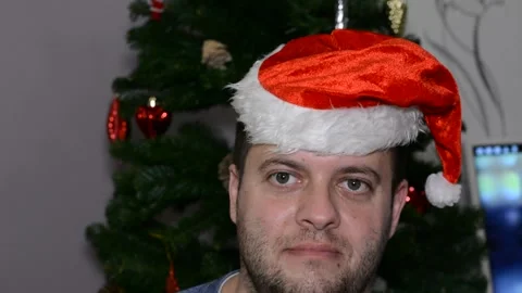 A man in a santa hat makes a face.  close-up Stock Footage 145123029