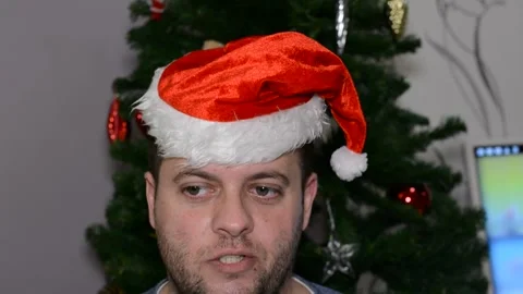 A man in a santa hat makes a face.  close-up Stock Footage 145123860