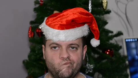 A man in a santa hat makes a face.  close-up Stock Footage 145123895