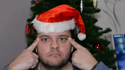 A man in a santa hat makes a face.  close-up Stock Footage 145123897