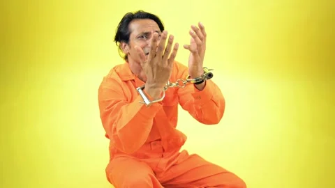 Man sat in despair bound by handcuffs feeling guilty Stock Footage 295926478