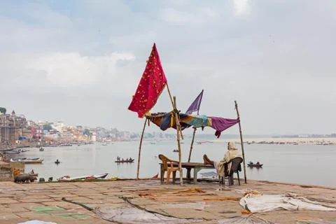 Man sat looking at the view of the Ganges at Varanasi, India. Stock Photos