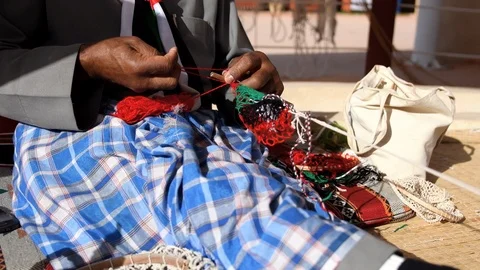 Man from Saudi Arabia doing handcraft work. He is preparing a fishing net Stock Footage 103244706