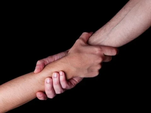 Man saving, rescuing and helping woman by holding or griping the forearm. Mal Stock Photos