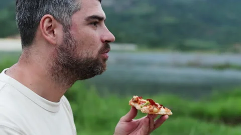 Man savoring every bite of his tasty pizza. Stock Footage 288979027