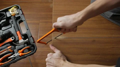 A Man Saw Cuts A Board Stock Footage 144775476