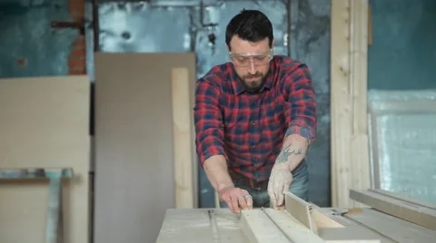 The man sawed a board in half on a circular saw Stock Footage 61540682