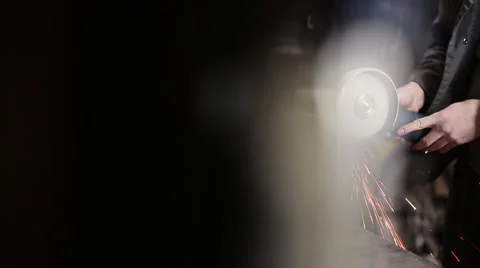 Man sawing metal by grinder, filmed with a slider Stock-Footage 59641548