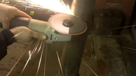 Man sawing metal by grinder, working environment Stock Footage 83324633