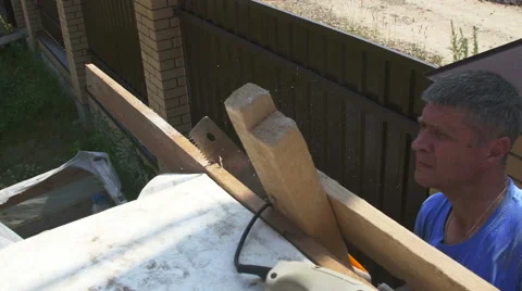 A man sawing the plank Stock Footage 64777077