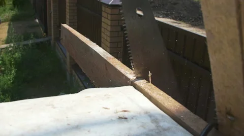 A man sawing the plank Stock Footage 64777117